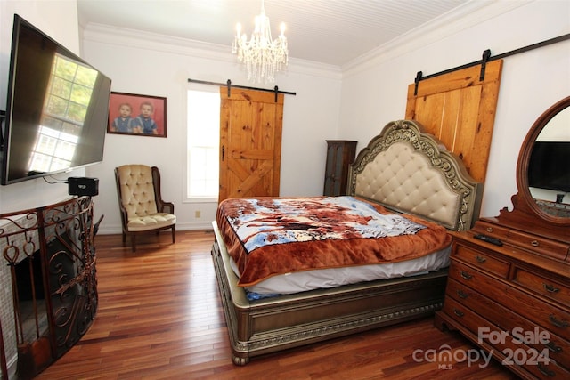 bedroom featuring dark hardwood / wood-style flooring, a barn door, and ornamental molding