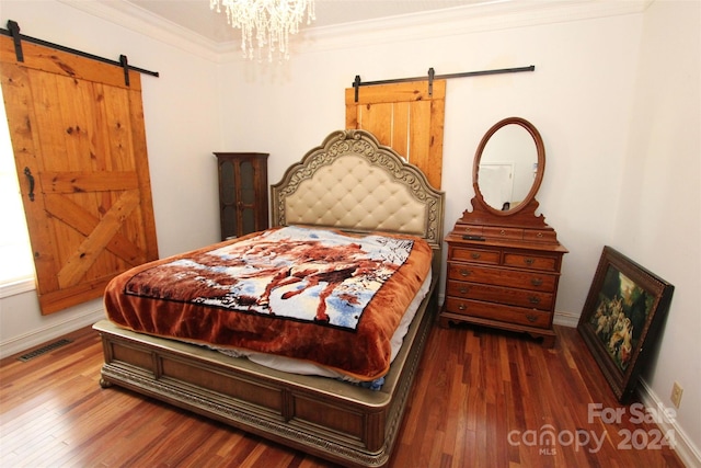2034 Haileys Ferry Rd, Lilesville, NC 28091 - bedroom with a barn door, wood finished floors, ornamental molding, baseboards, and a chandelier