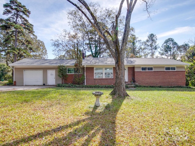 ranch-style house featuring a garage and a front lawn