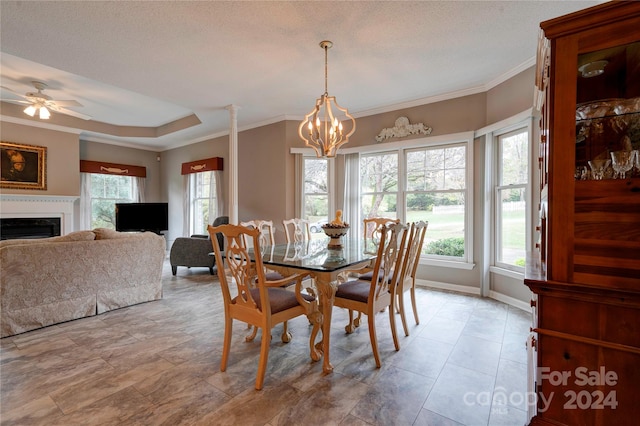 dining room featuring ceiling fan with notable chandelier, a textured ceiling, and crown molding