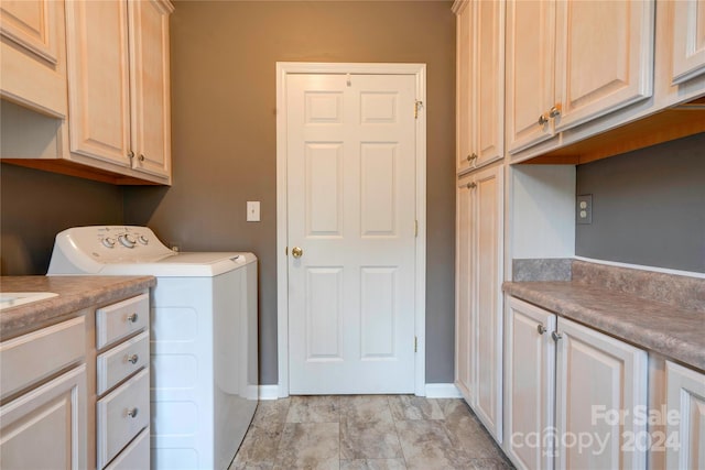 washroom featuring washer and clothes dryer and cabinets