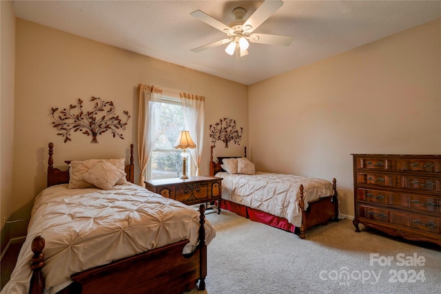 bedroom with carpet, a textured ceiling, and ceiling fan