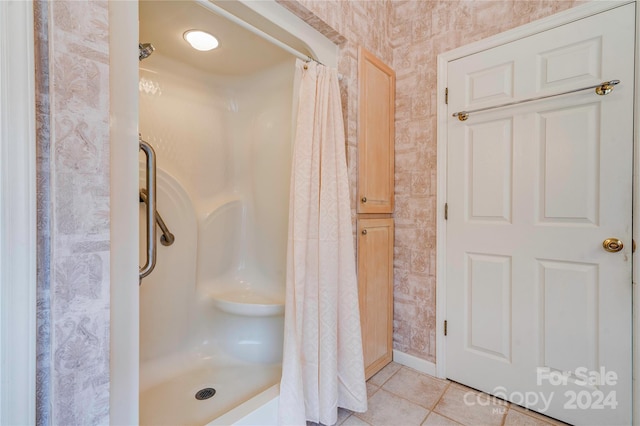 bathroom with walk in shower and tile patterned floors