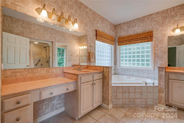 bathroom featuring vanity, plus walk in shower, tile patterned floors, and plenty of natural light