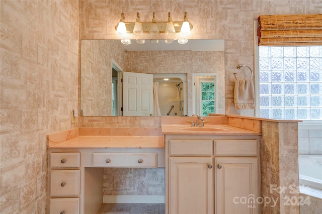 bathroom featuring independent shower and bath and vanity