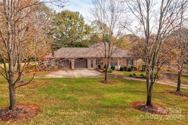 ranch-style home featuring a garage and a front lawn