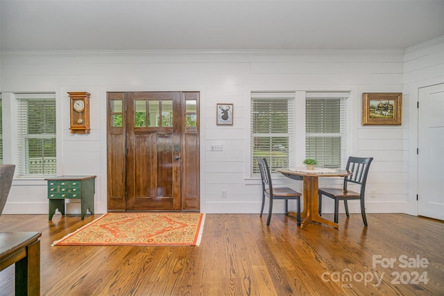 dining area with hardwood / wood-style floors and crown molding