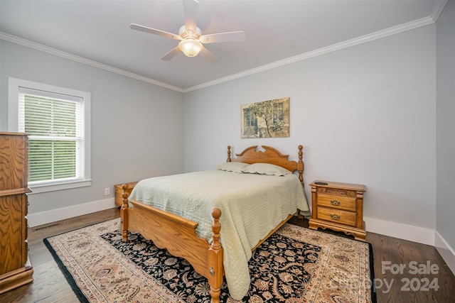 bedroom with ceiling fan, dark hardwood / wood-style floors, and crown molding