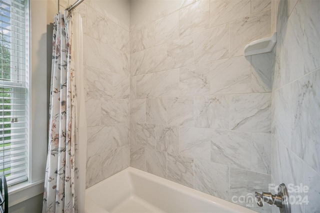 bathroom with shower / bathtub combination with curtain