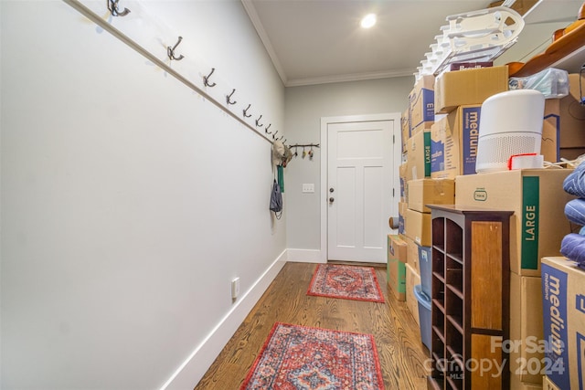 doorway to outside with hardwood / wood-style flooring and ornamental molding