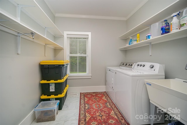 laundry area featuring sink, separate washer and dryer, and crown molding