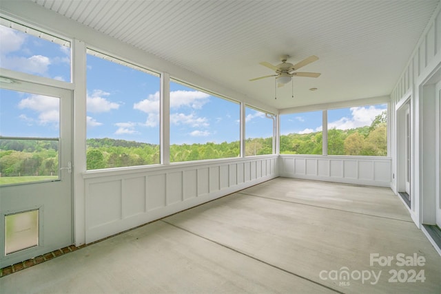 unfurnished sunroom with ceiling fan