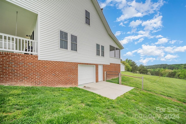 view of property exterior featuring a yard and a garage