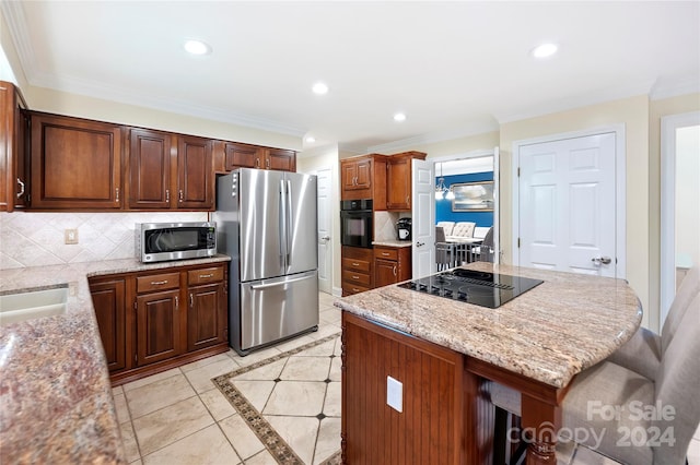 kitchen with black appliances, light stone counters, light tile patterned flooring, a kitchen bar, and decorative backsplash