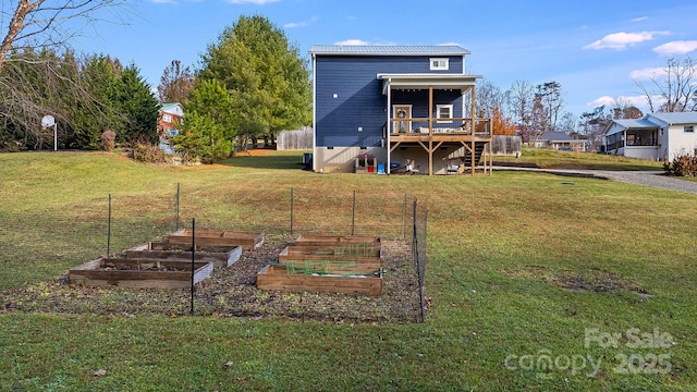 rear view of property featuring a wooden deck and a lawn