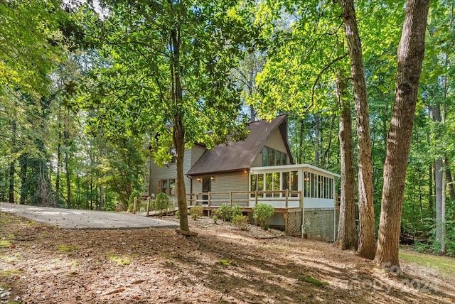 back of property with a sunroom