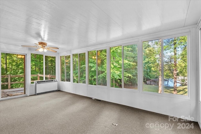 unfurnished sunroom with a wealth of natural light and ceiling fan