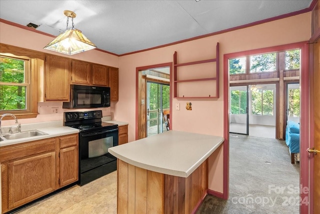 kitchen with sink, black appliances, ornamental molding, light colored carpet, and pendant lighting