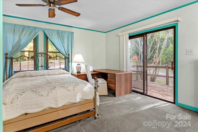 carpeted bedroom featuring access to outside, a textured ceiling, and ceiling fan