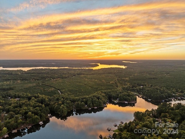 aerial view at dusk with a water view