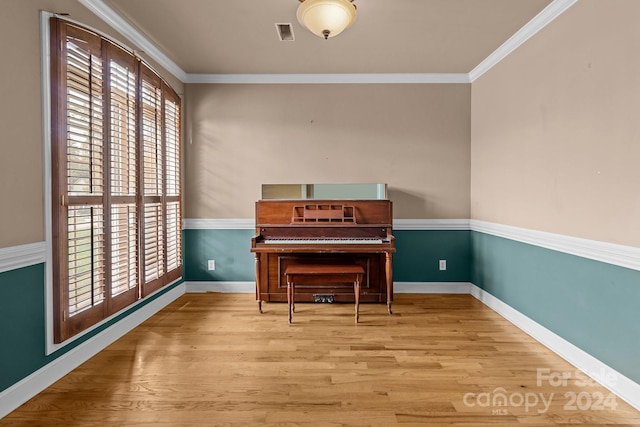 miscellaneous room with wood-type flooring and ornamental molding