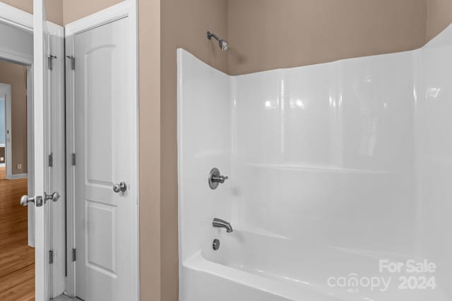 bathroom featuring tub / shower combination and hardwood / wood-style flooring