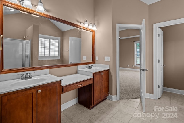 bathroom with tile patterned floors, vanity, lofted ceiling, and a shower with door