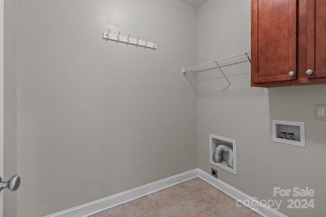 clothes washing area featuring cabinets and hookup for a washing machine