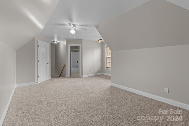 additional living space featuring carpet, vaulted ceiling, and ceiling fan