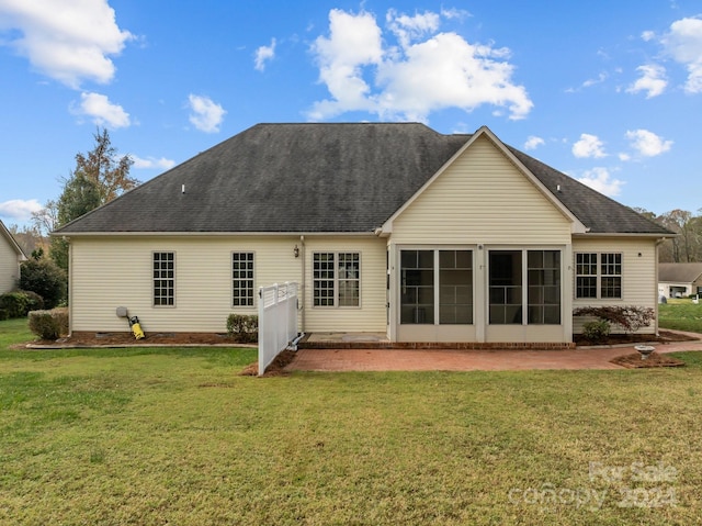 rear view of house with a yard