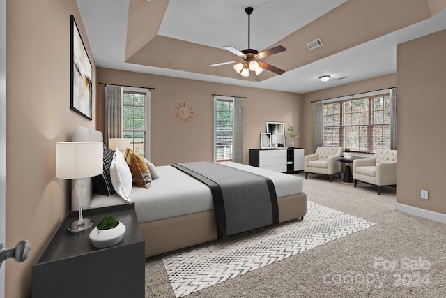 carpeted bedroom featuring ceiling fan and multiple windows