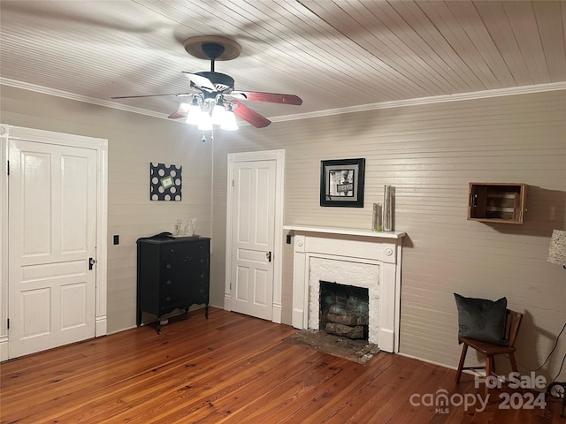 unfurnished living room featuring wood ceiling, ceiling fan, wood-type flooring, and ornamental molding