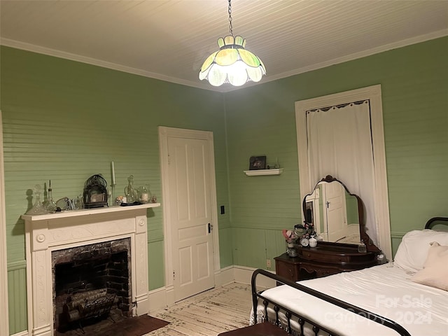 bedroom with hardwood / wood-style floors and ornamental molding