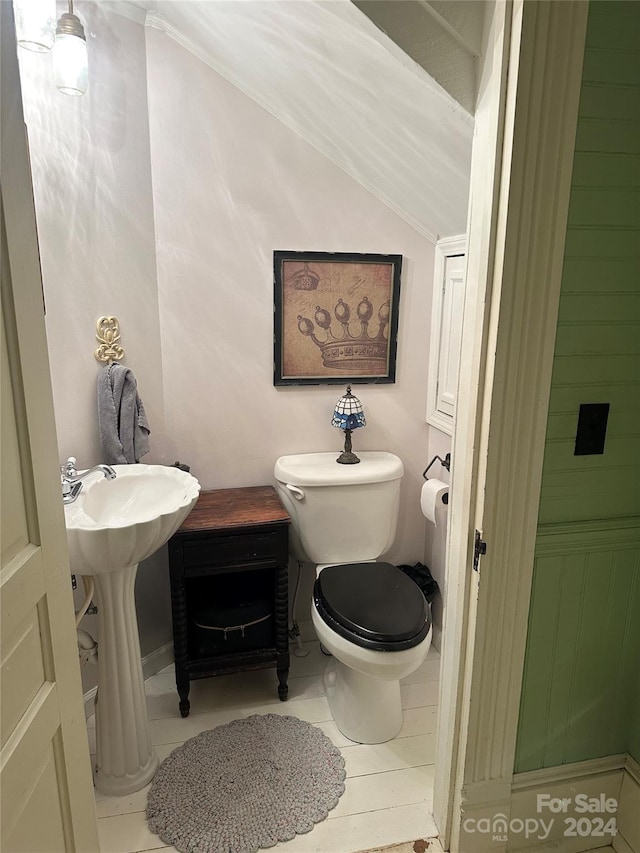 bathroom featuring tile patterned floors, lofted ceiling, and toilet