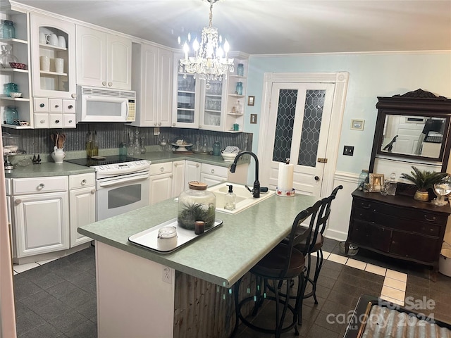 kitchen with white cabinetry, tasteful backsplash, pendant lighting, white appliances, and ornamental molding