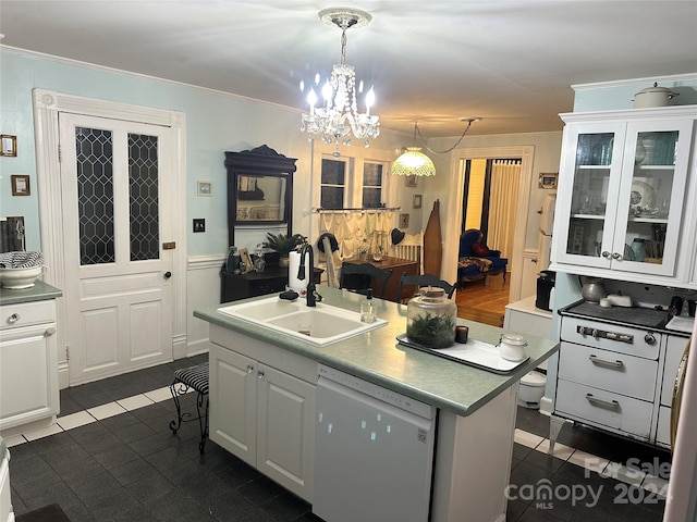 kitchen featuring pendant lighting, white dishwasher, sink, an island with sink, and white cabinetry