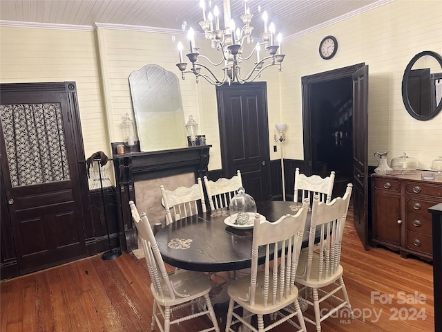 dining area with a chandelier, dark wood-type flooring, and ornamental molding