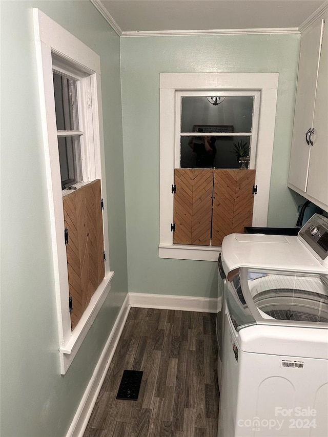 clothes washing area featuring crown molding, cabinets, independent washer and dryer, and dark wood-type flooring