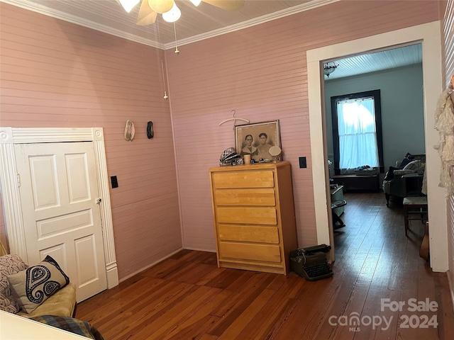 hallway with dark hardwood / wood-style flooring and ornamental molding