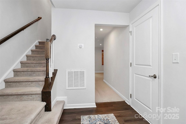 stairs with hardwood / wood-style flooring