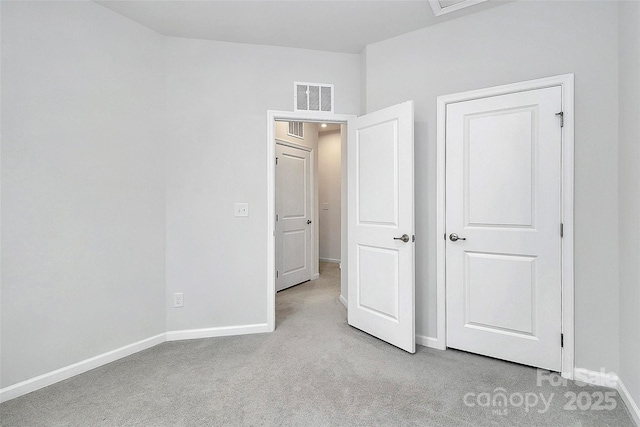 unfurnished bedroom with light colored carpet