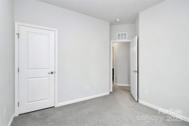 spare room featuring light colored carpet