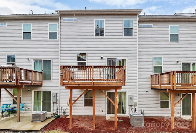 back of house featuring central AC unit and a patio area