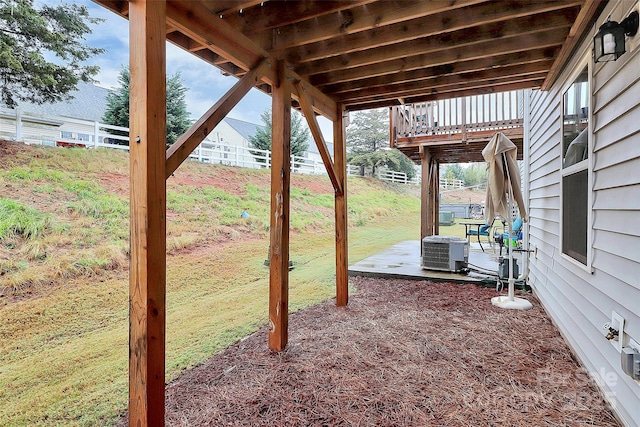 view of yard with central AC unit and a patio