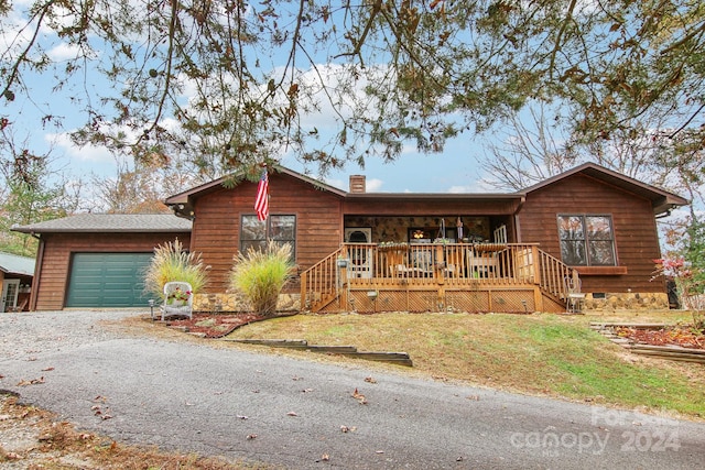 view of front facade with a garage and a porch