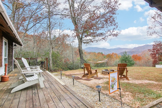 deck featuring a mountain view and an outdoor fire pit