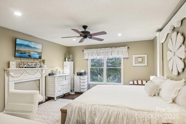 bedroom featuring ceiling fan, dark wood-type flooring, and a textured ceiling