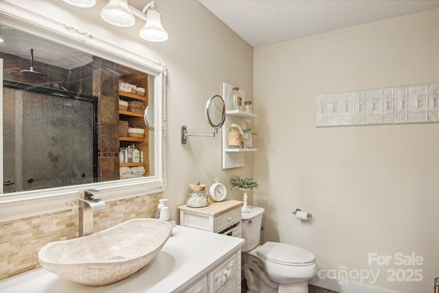 bathroom featuring vanity, toilet, and an enclosed shower