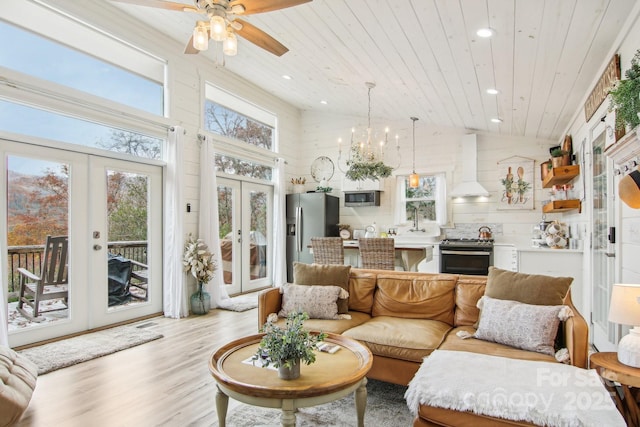 living room featuring french doors, an inviting chandelier, light hardwood / wood-style floors, and wooden ceiling