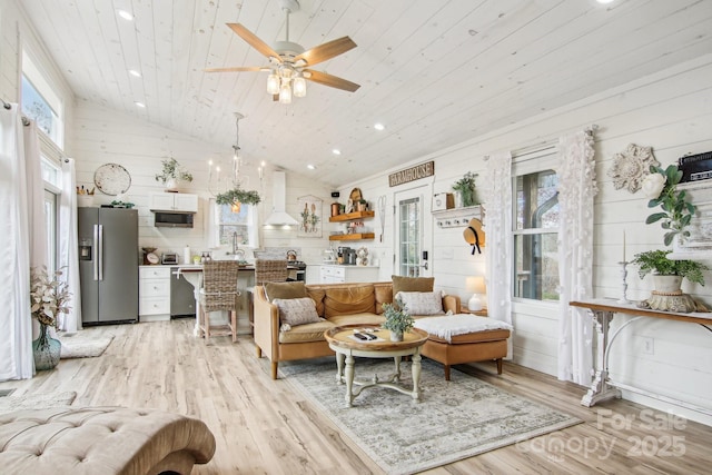 living room featuring ceiling fan, high vaulted ceiling, wood ceiling, and light hardwood / wood-style floors